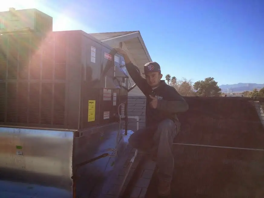 HVAC technician performing AC Tune-Up on a rooftop unit in Islamorada, Village of Islands